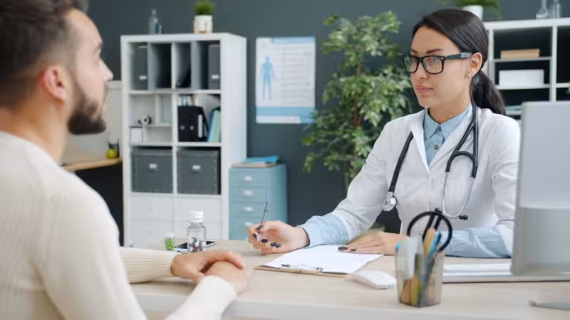 Booking an Appointment: A doctor and patient during a consultation Doctor and patient consultation for Booking an Appointment - Patient Testimonials For Surbiton: Private Microsuction Ear Wax...